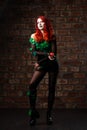 poison ivy comics character cosplay. Halloween costume. young sexy woman in a vine, leaves and poison ivy costume posing