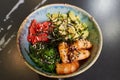 A poke bowl with Chuka Wakame seaweed, wasabi, avocado, cashew, nori, shrimps