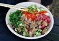 poke bowl colorful detail with cucumber, octopus, masago, seaweed salad, edamame, soy beans, ponzu sauce, salmon) Royalty Free Stock Photo