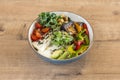 Poke bowl with pumpkin and sunflower seeds, ripe avocado, fresh cheese, chopped bell pepper, cherry tomatoes, Royalty Free Stock Photo