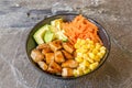 Poke bowl with ripe avocado, yakisoba chicken, sweet corn