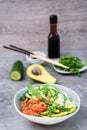 Poke bowl with salmon, cucumber, avocado, arugula and seasame seeds Royalty Free Stock Photo