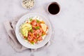 Poke bowl with salmon, rice, avocado, sesame seeds, micro greens, pepper and soy sauce on grey backround Royalty Free Stock Photo