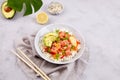 Poke bowl with salmon, rice, avocado, sesame seeds, micro greens, pepper and soy sauce. Royalty Free Stock Photo
