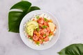 Poke bowl with salmon or tuna, rice, avocado, sesame seeds, micro greens. Hawaiian diet food with fish, pokebowl. Royalty Free Stock Photo