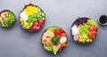 Poke bowl set with tuna, salmon, shrimp with avocado, mango, radish, rice and other ingredients. Soy sauce and sesame dressing. Royalty Free Stock Photo