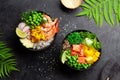 Poke bowls with shrimps, salmon, avocado and mango