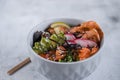 Poke in a gray bowl on a light gray background. Hawaiian cuisine.