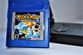 Pokemon Blue GameBoy and game 2 sideview Royalty Free Stock Photo