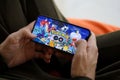 Pokemon GO mobile iOS game on iPhone 15 smartphone screen in male hands during mobile gameplay