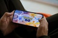 Pokemon GO mobile iOS game on iPhone 15 smartphone screen in male hands during mobile gameplay