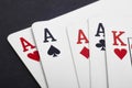 Poker card game with four aces and king. Black background Royalty Free Stock Photo