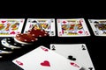 Poker cards and chips on black. Pair of aces, shallow d Royalty Free Stock Photo
