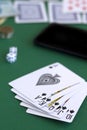 Poker cards and chips.black royal flush cards with dice and phone in casino Royalty Free Stock Photo