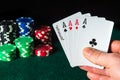 Poker cards with five of a kind highest combination in the game. Close-up of a gambler hand is holding playing cards in poker club