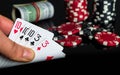 Poker cards with full house or full boat combination. Close up of gambler hand takes playing cards in casino Royalty Free Stock Photo