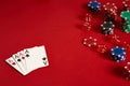 Poker cards and gambling chips on red background