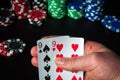 Poker cards with one pair combination. Close up of a gambler hand is holding playing cards in casino