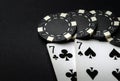 Poker cards with one pairs winning combination in casino. Chips and cards on the black table