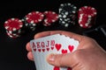 Poker cards with a royal flush combination. Close-up of a gambler hand is holding playing cards in casino