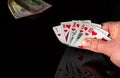 Poker cards with royal flush combination. Close-up of a gambler hand is holding playing cards in casino