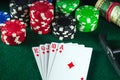 Poker cards with royal flush combination in poker club. Chips and money on the green table Royalty Free Stock Photo