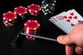 Poker cards with royal flush set combination. Rake in hand takes chips in the casino Royalty Free Stock Photo