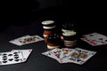 Poker cards and stacks, lot of chips over black. All in, four of Royalty Free Stock Photo