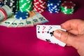 Poker cards with three of a kind or set combination. Close up of gambler hand takes playing cards in casino Royalty Free Stock Photo