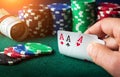 Poker cards with three of a kind or set combination. Close up of gambler hand takes playing cards in casino Royalty Free Stock Photo