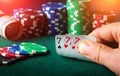Poker cards with three of a kind or set combination. Close up of gambler hand takes playing cards in casino Royalty Free Stock Photo