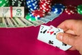 Poker cards with three of a kind or set combination. Close up of gambler hand takes playing cards in casino Royalty Free Stock Photo