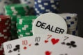 Poker Chips cards and dealer sign showing full house with 10 and ace in close up