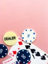 Poker chips and cards on a pink background. The game of poker. Chip dealer. Place for text. Royalty Free Stock Photo