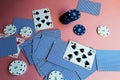 Poker chips and cards on a pink background. The game of poker. Gambling.