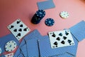 Poker chips and cards on a pink background. The game of poker. Gambling.