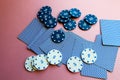 Poker chips and cards on a pink background. The game of poker. Gambling