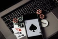 Poker chips, cards and smartphone on a grey keyboard. Poker online concept Royalty Free Stock Photo