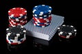 Poker chips on a deck of cards for playing poker on a black background with reflection Royalty Free Stock Photo