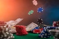 Poker chips falling on a table in a casino against a background of money. Casino game, poker and online business Royalty Free Stock Photo