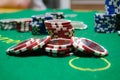 Poker chips with playing cards on a green table