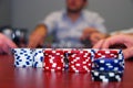 Poker Chips with Players in Background Royalty Free Stock Photo