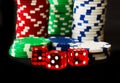 Poker Chips with Red Dice in forground on black backgrund with reflections Royalty Free Stock Photo