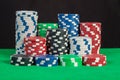 Poker chips stack on green table black background Royalty Free Stock Photo