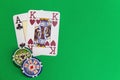 Poker chips stack and playing cards on green table. Royalty Free Stock Photo