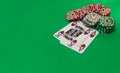 Gambling chips stack and playing cards on green table Royalty Free Stock Photo