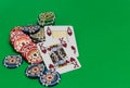 Poker chips stack and playing cards on green table Royalty Free Stock Photo