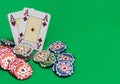 Poker chips stack and playing cards on green table. Royalty Free Stock Photo