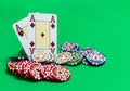 Poker chips stack and playing cards on green table Royalty Free Stock Photo