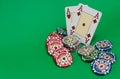 Poker chips stack and playing cards on green table Royalty Free Stock Photo